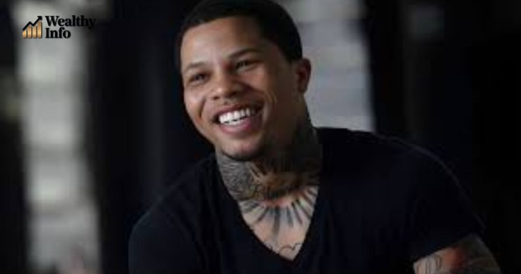 A smiling tattooed man in a casual black shirt, used in an article discussing Demetris Fenwick Net Worth.