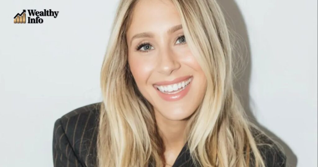 Lisa Gilroy smiling in a black outfit, showcasing her charm and success as a comedian and actress with a growing net worth in 2025.