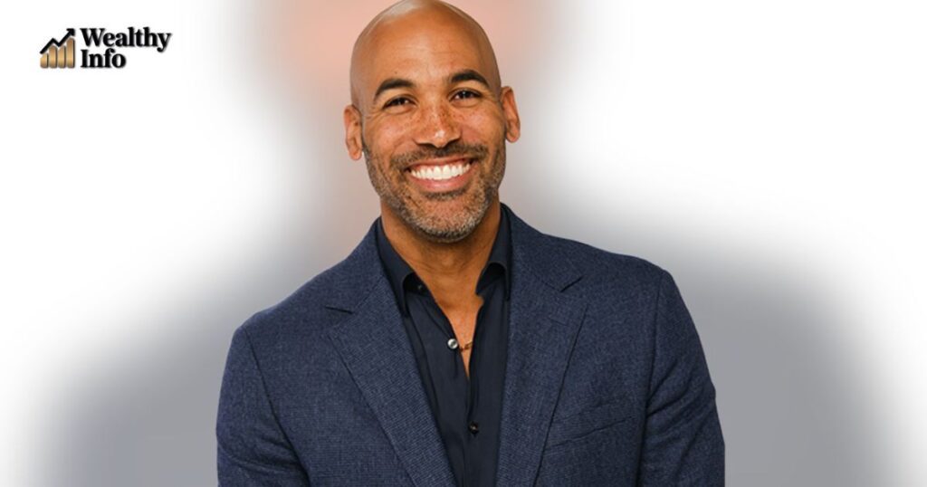 Melvin Robert smiling confidently in a blue suit — Melvin Robert Net Worth 2025 and media career profile